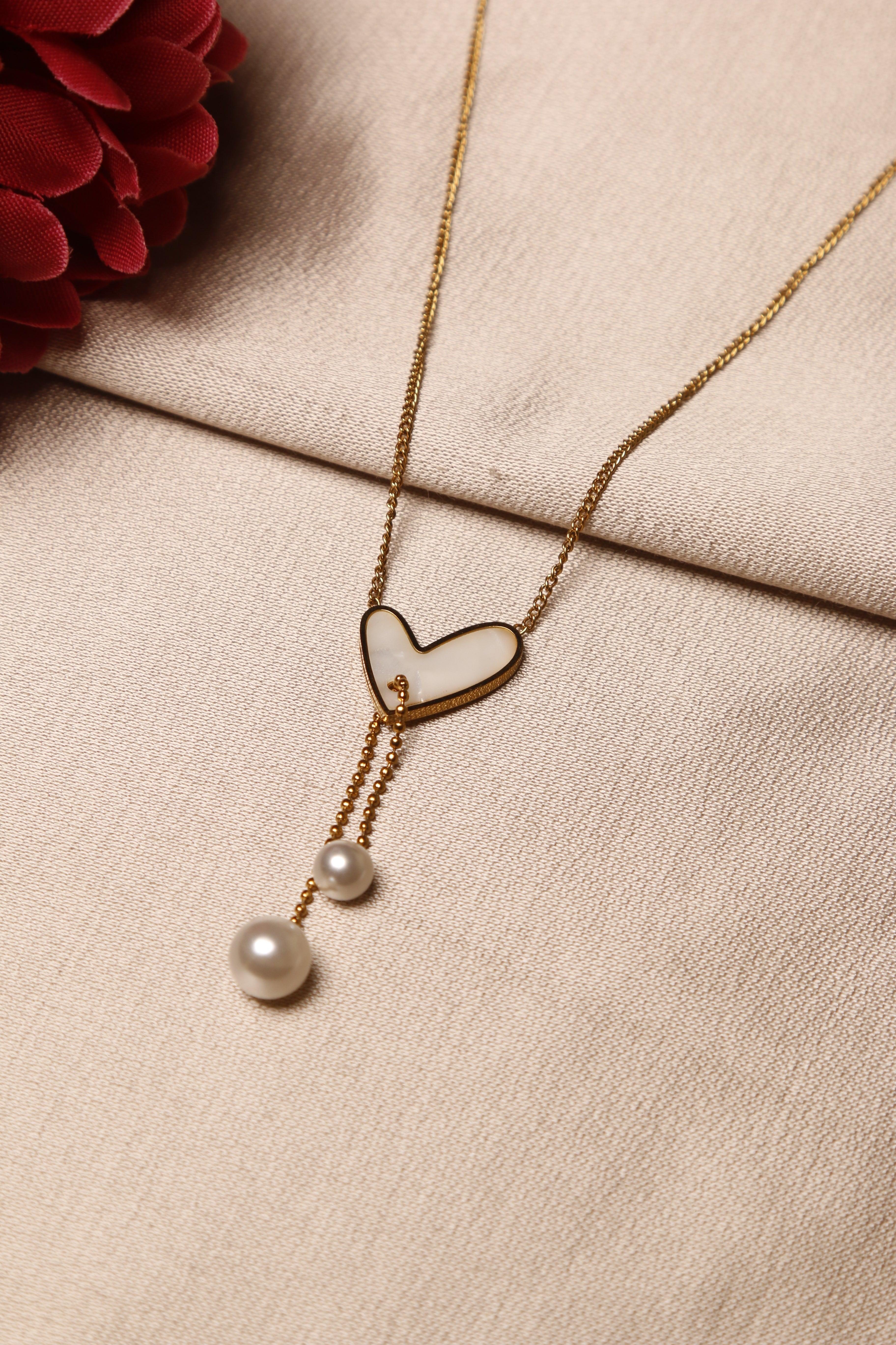 gold heart-shaped necklace with two pearl 