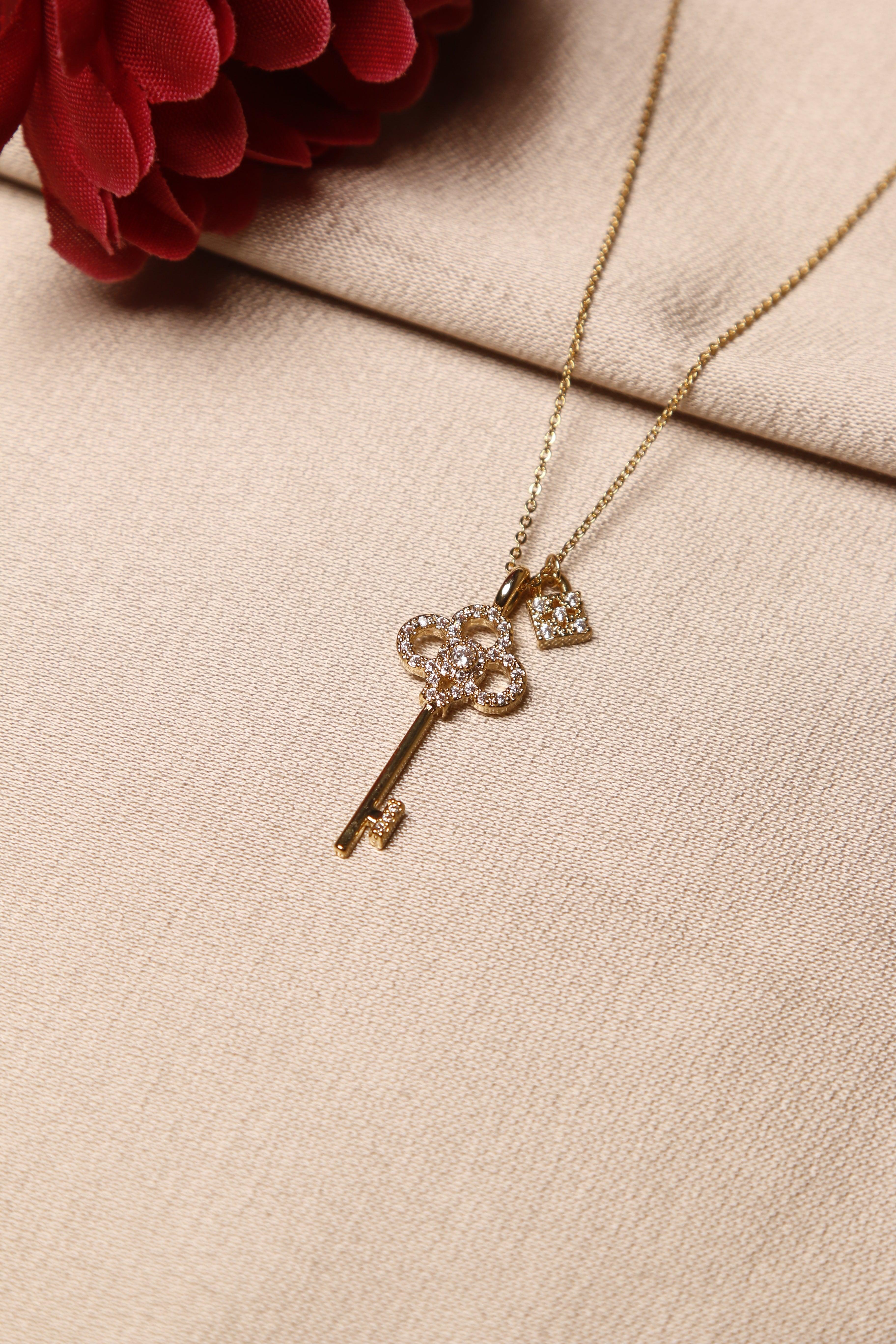 delicate gold key-shaped necklace adorned with sparkling diamonds