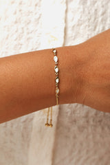 Gold-tone bracelet with sleek oval mirror charms.
