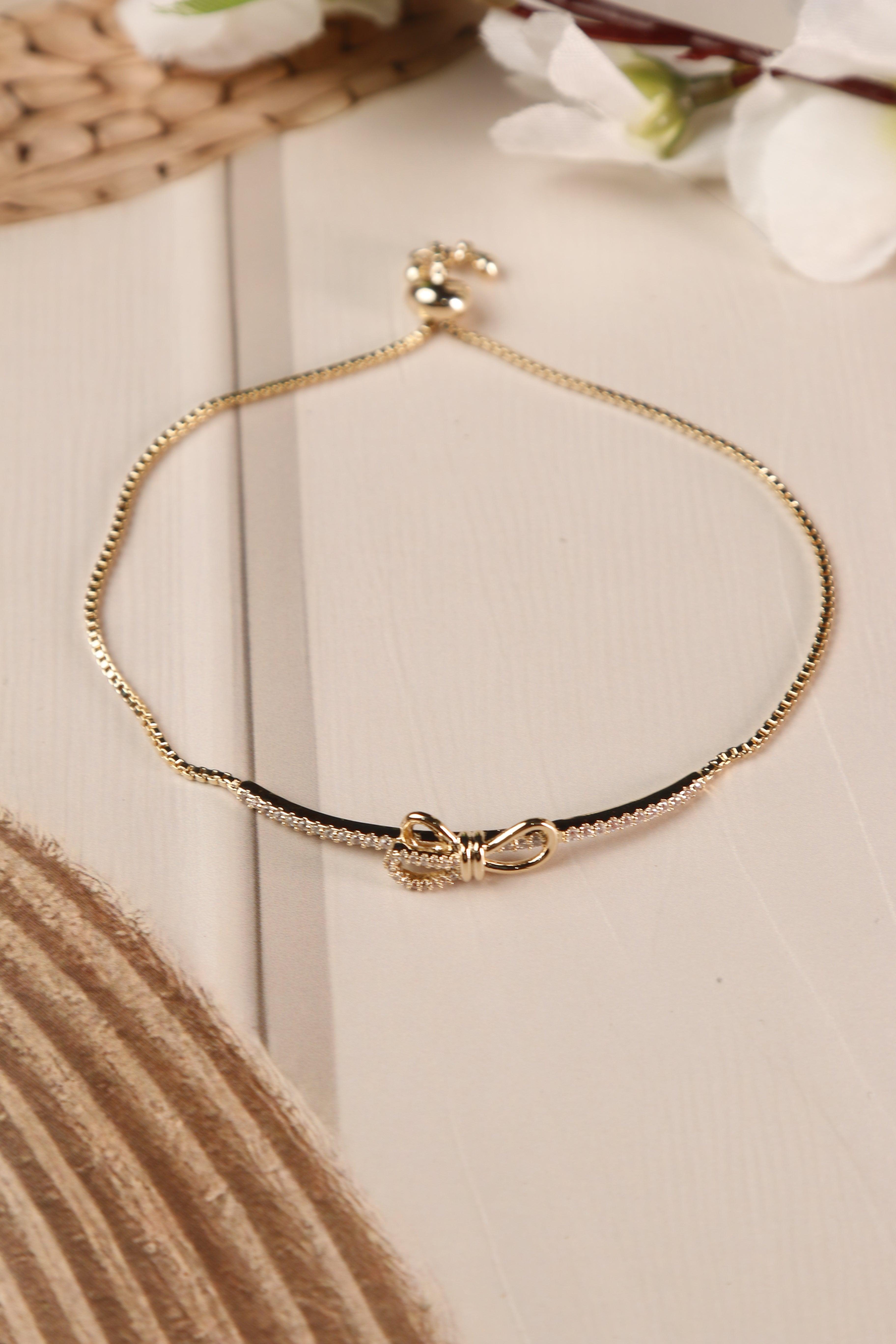 Adjustable anti-tarnish bracelet with elegant bow design.