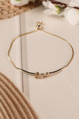 Adjustable anti-tarnish bracelet with elegant bow design.