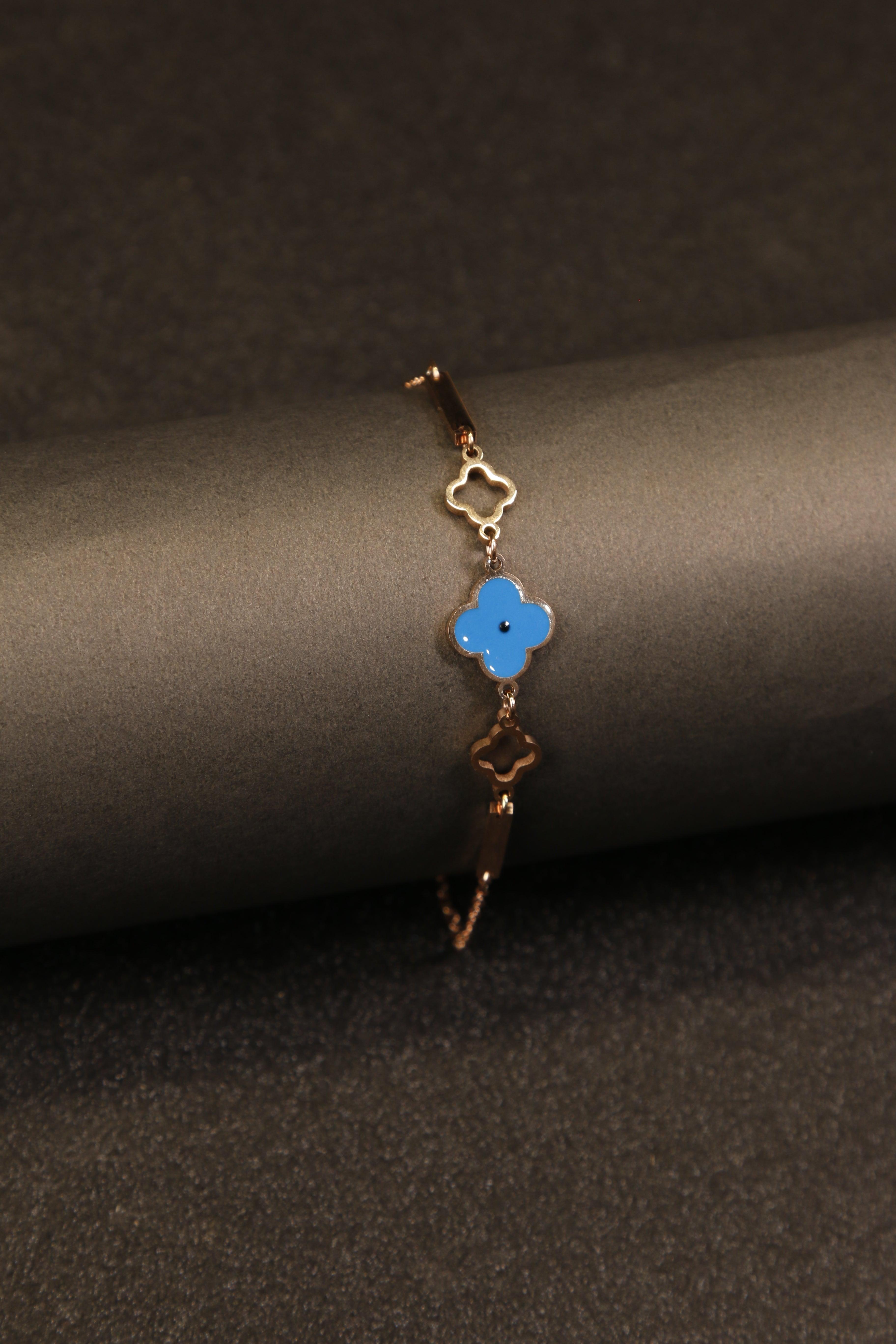 Anti-tarnish bracelet with vibrant blue clover detail.