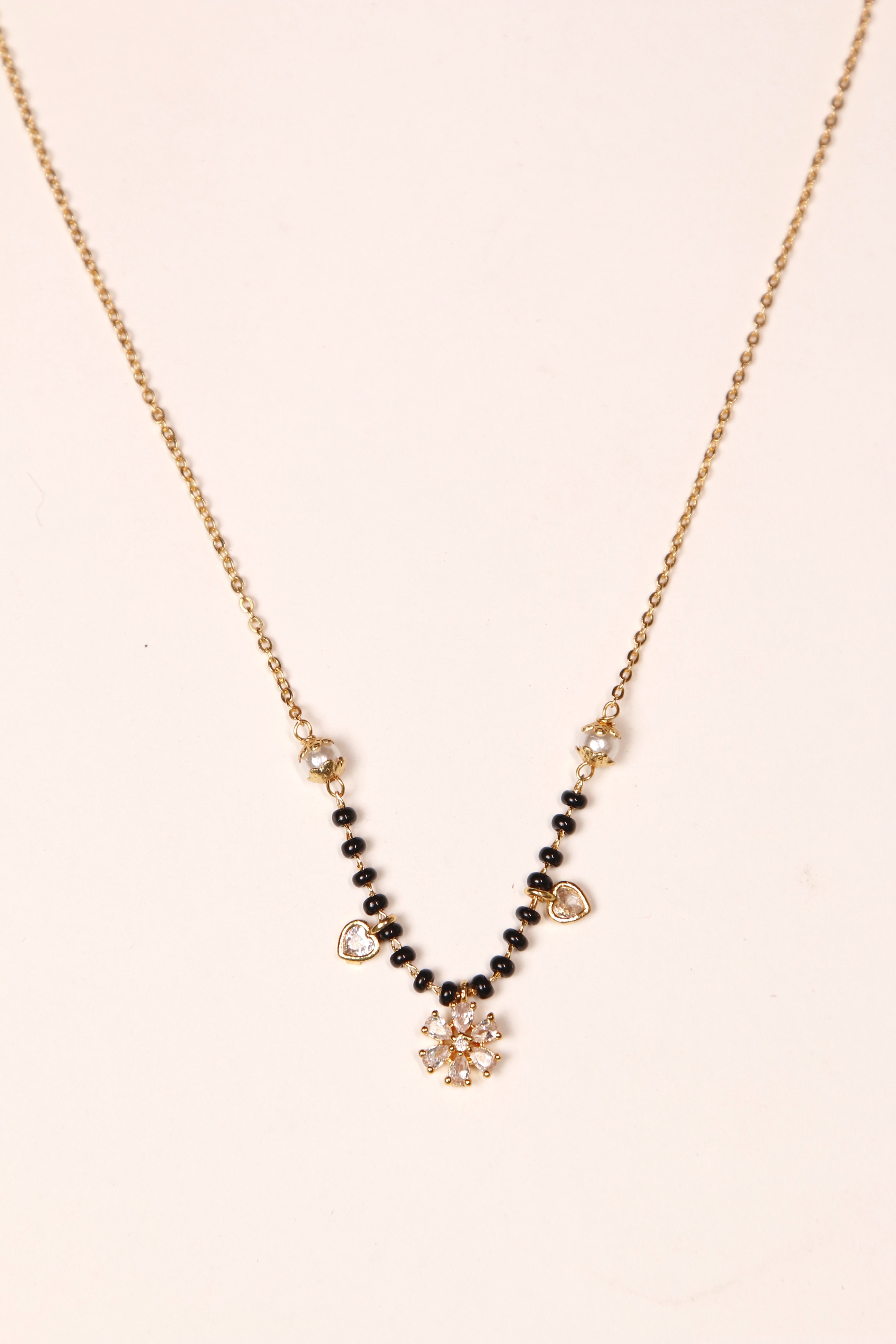 Gold mangalsutra with floral diamond pendant, pearls and heart charms