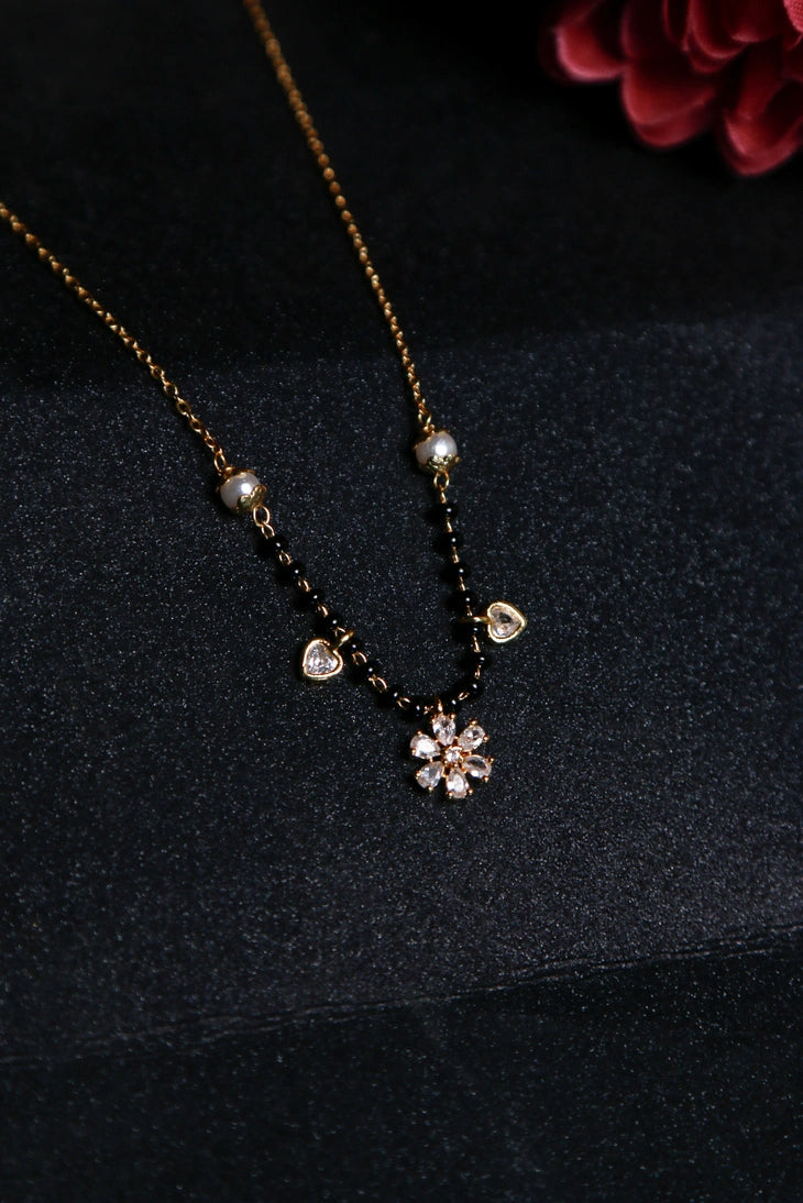 Gold mangalsutra with floral diamond pendant, pearls and heart charms