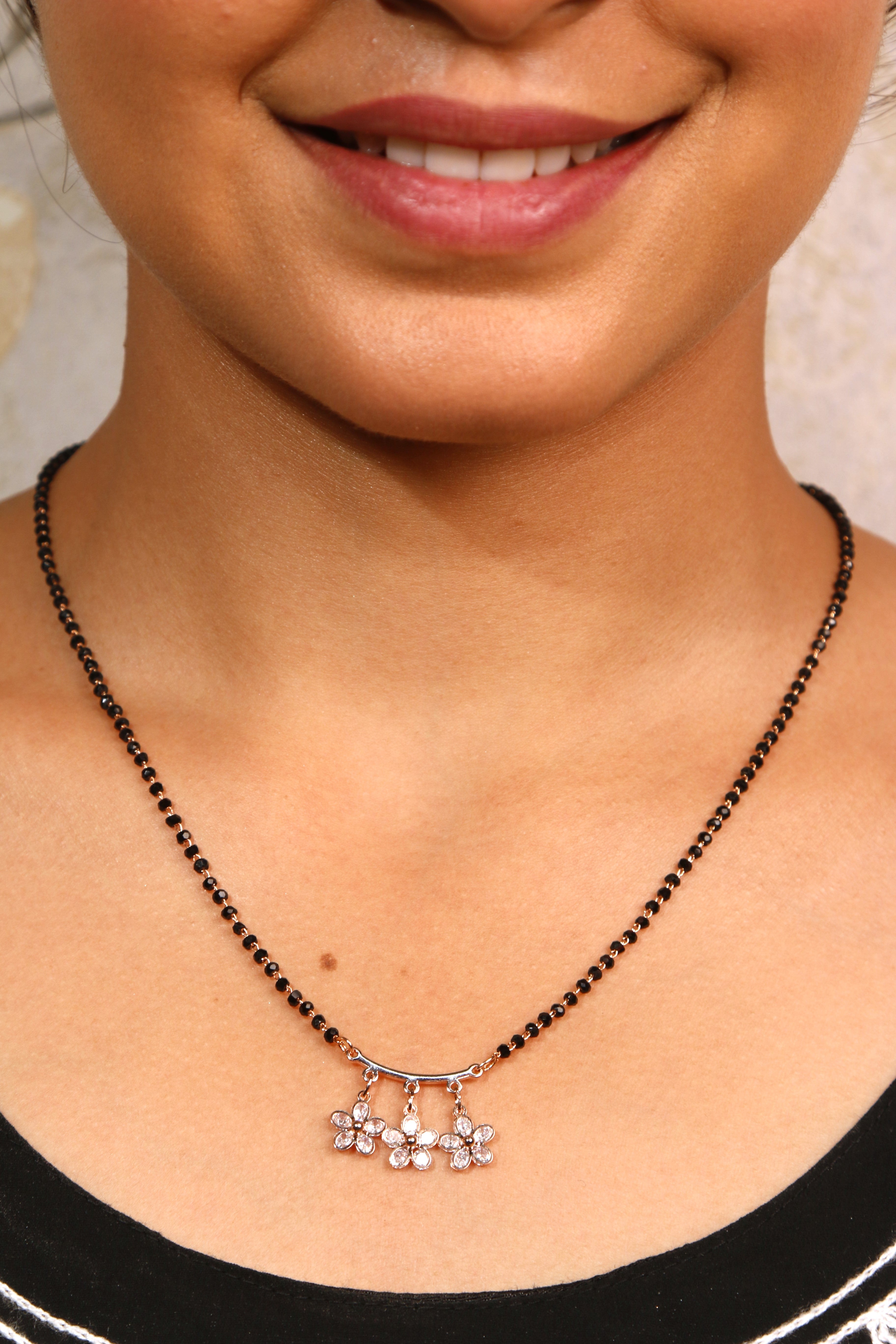 A beautiful flower diamond mangalsutra, designed with black beads.