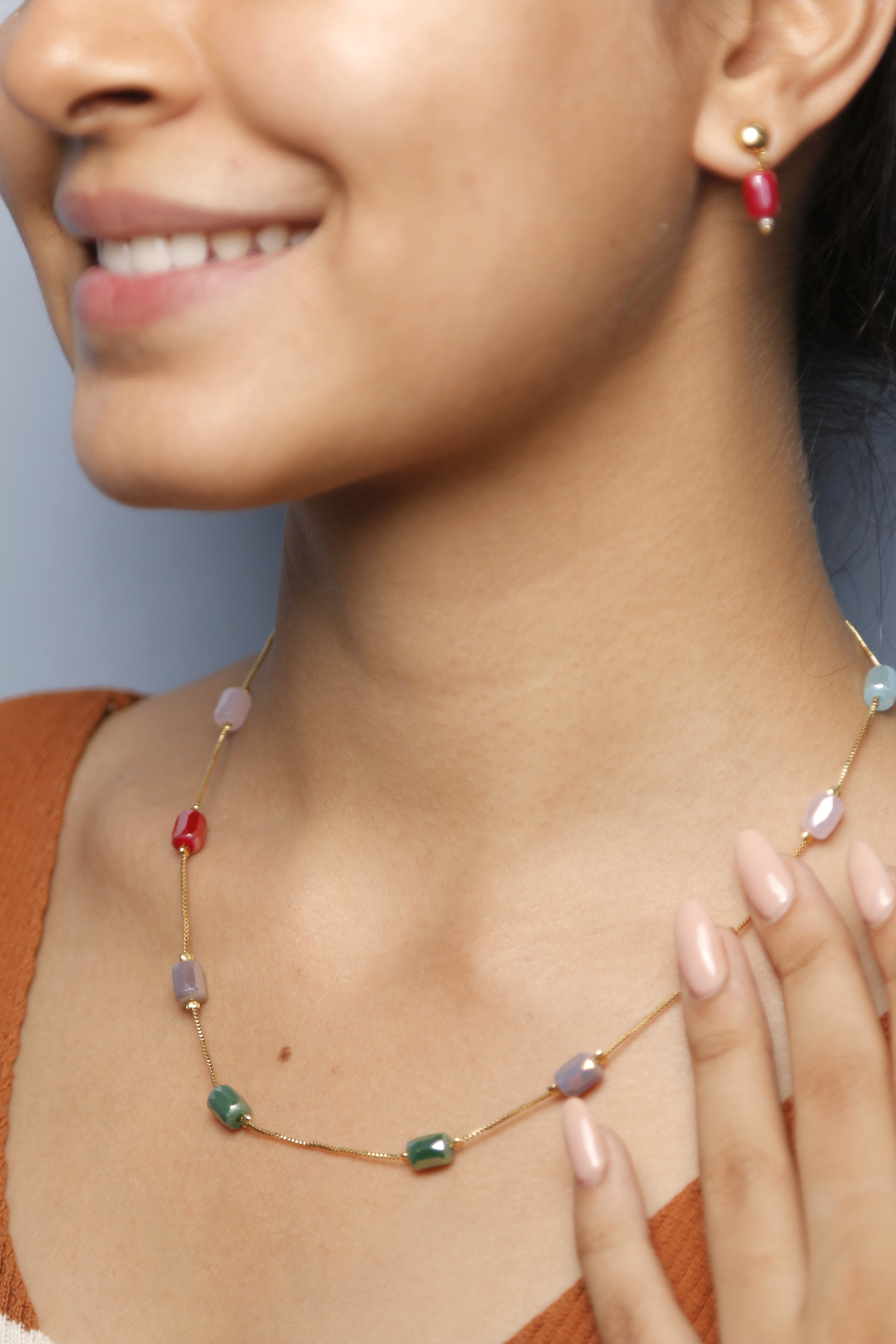 Close-up of a woman wearing a multicolored beaded necklace.