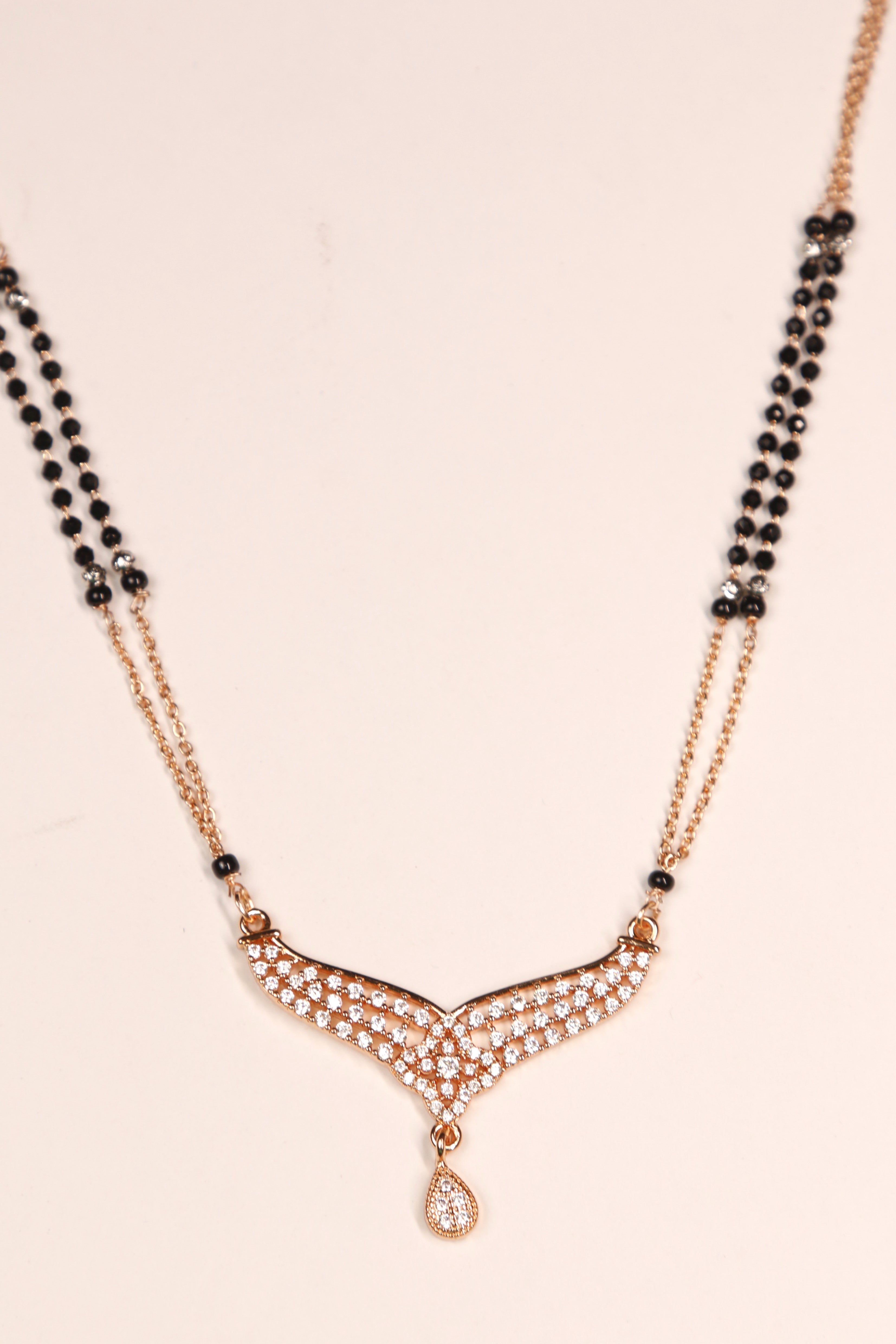 Rose gold designer mangalsutra with V-shaped diamond pattern and drop pendant
