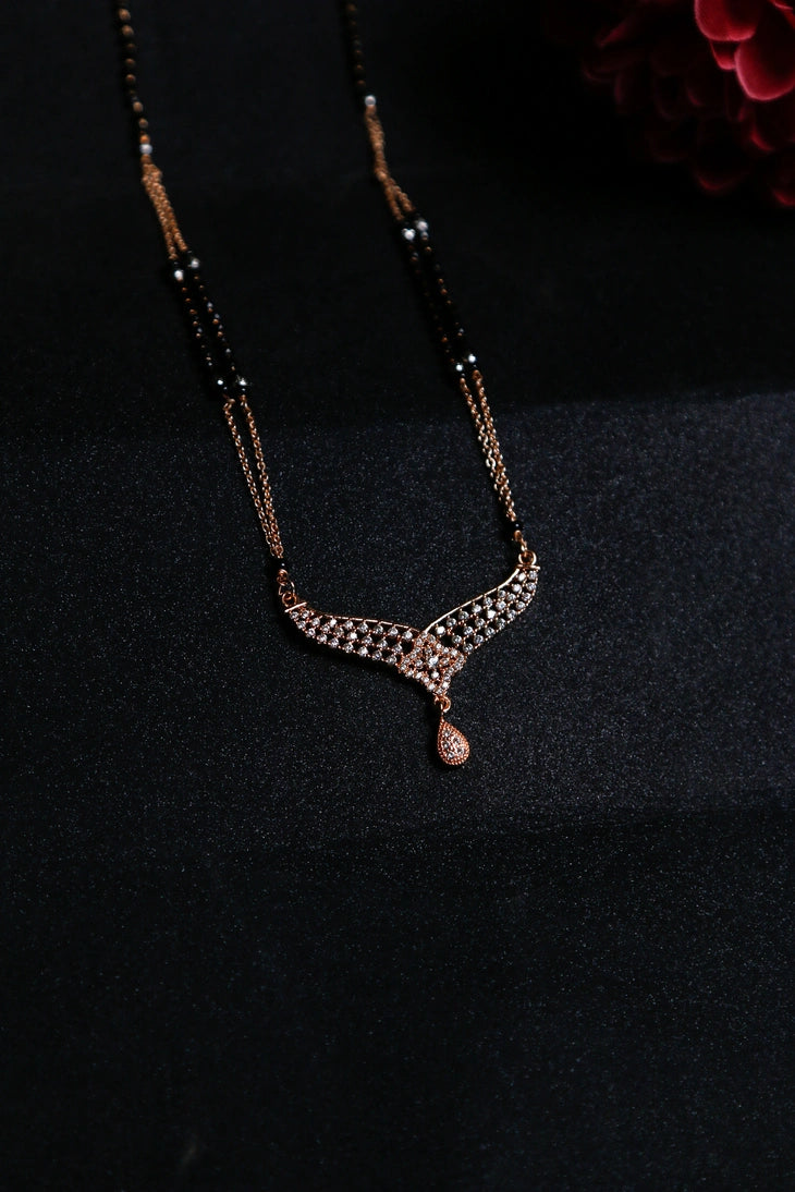 Rose gold designer mangalsutra with V-shaped diamond pattern and drop pendant