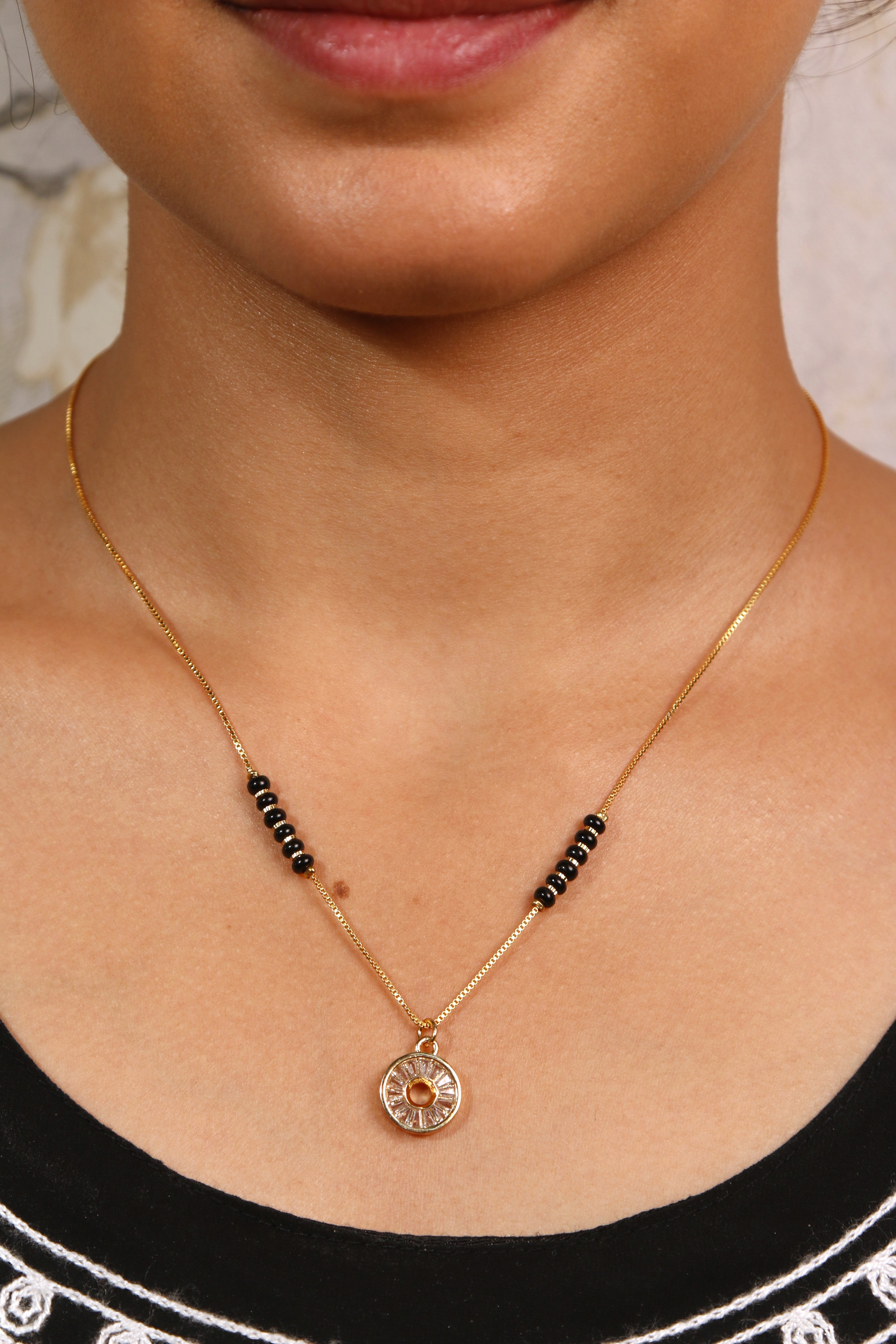 Elegant round crystal mangalsutra with black beads, a classic piece of jewelry with a shimmering circular pendant.
