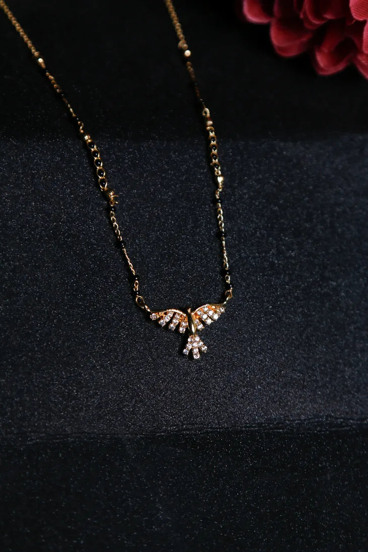 Gold mangalsutra with a wing-like pendant design